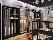 Il negozio di vestiti indipendente degli scaffali di esposizione dell'abbigliamento visualizza il materiale del metallo/MDF